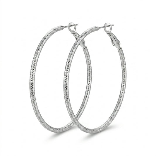 Silver Diamond-Cut Textured Hoop Earrings — Three-quarter angle view