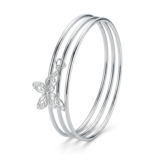 Silver Triple Bangle Set with Butterfly Charm — Three-quarter angle view