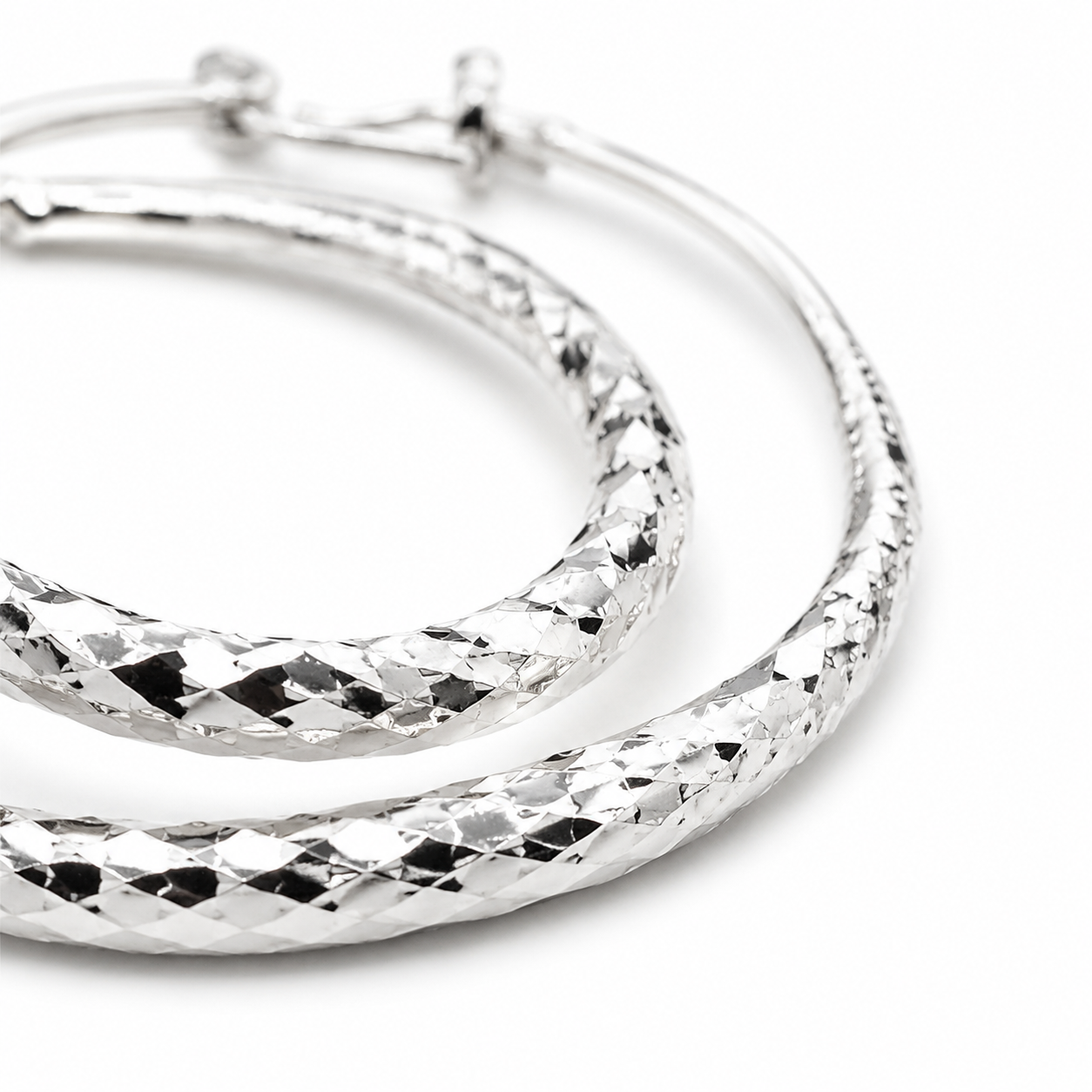 Silver Diamond-Cut Teardrop Hoop Earrings — Close-up detail